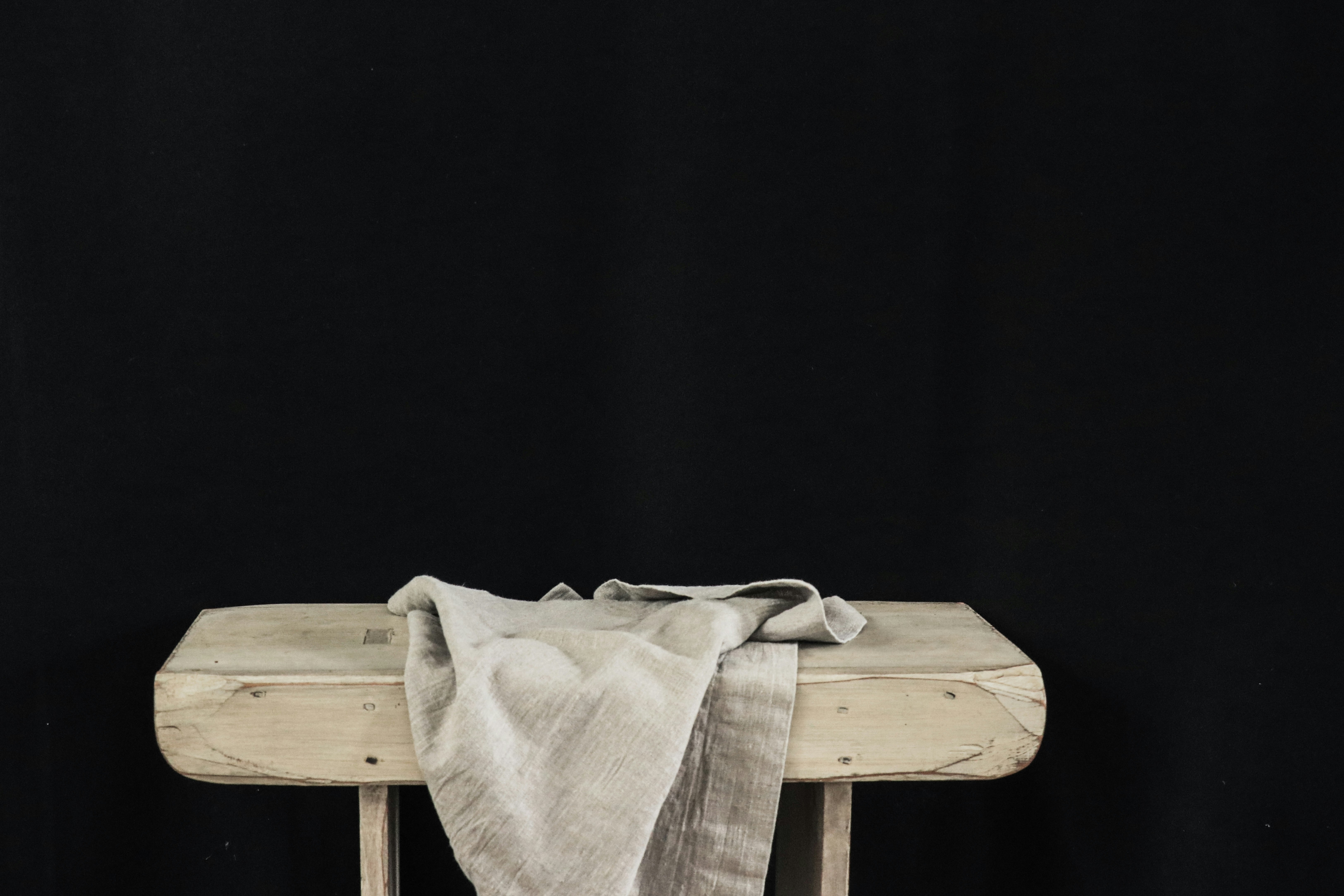 white textile on brown wooden table